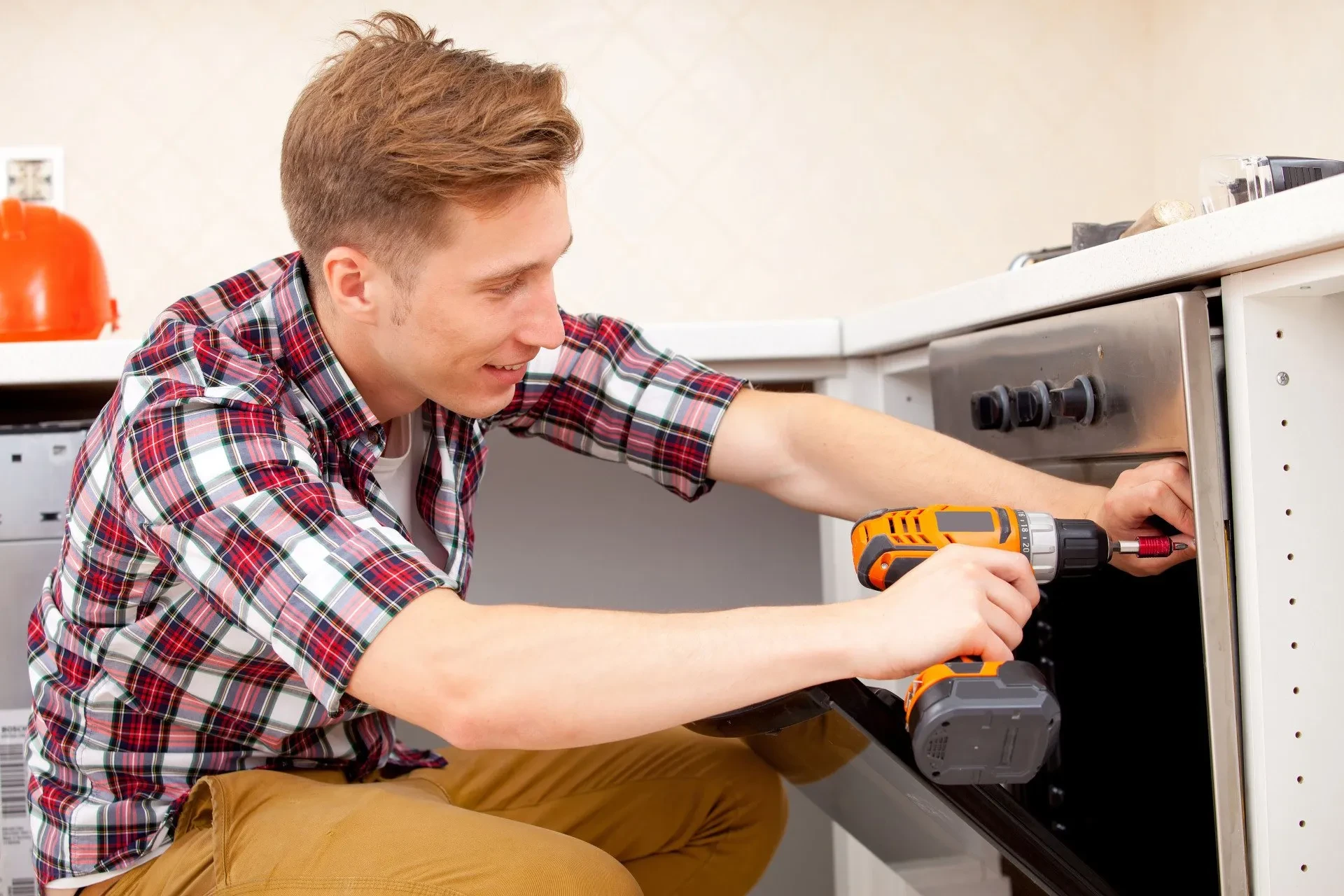 A technician repairing a dryer in a Wildwood home