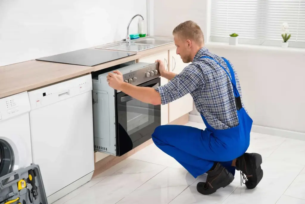 A service provider removing an old dishwasher for replacement in Lady Lake