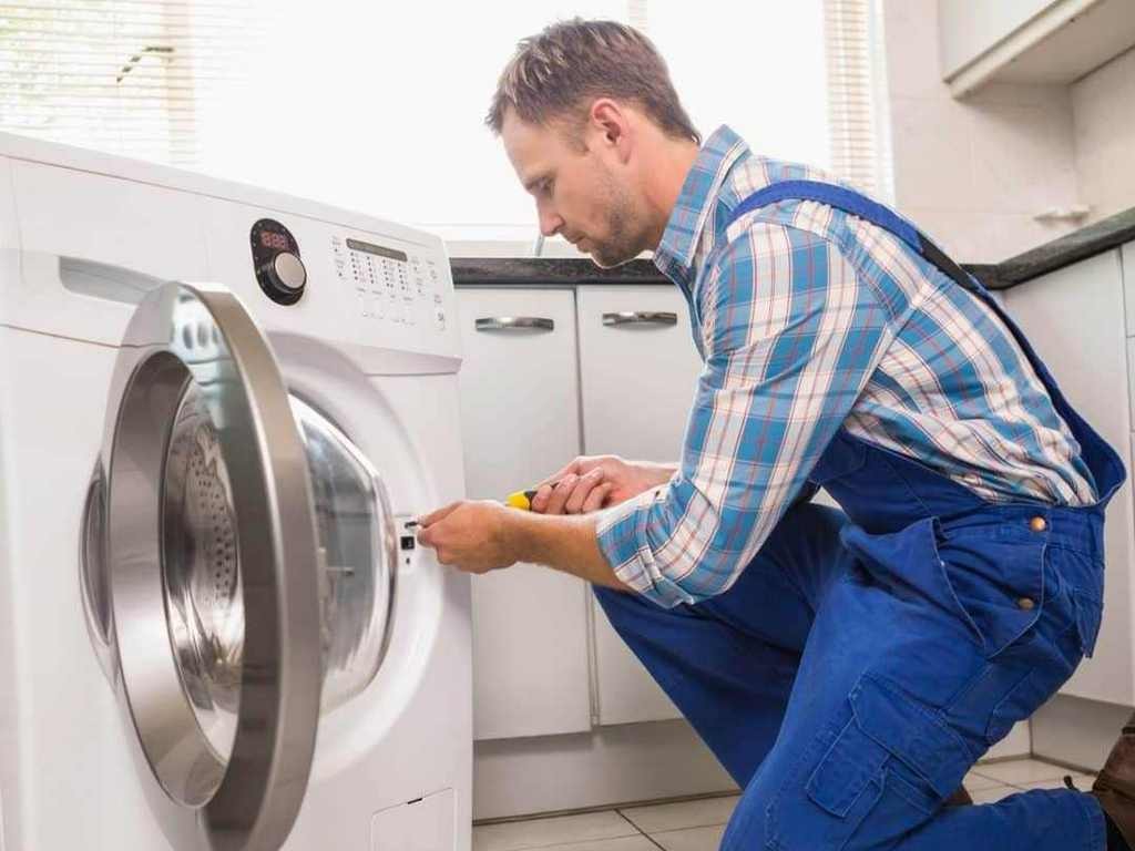 A technician repairing a dryer in a Jacksonville home