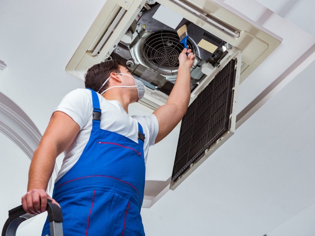 A technician adjusting dryer vents during an appliance installation in Jacksonville