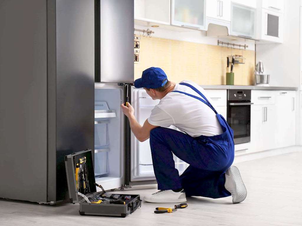A Appliance Repair troubleshooting a noisy dryer in a Jacksonville laundry room