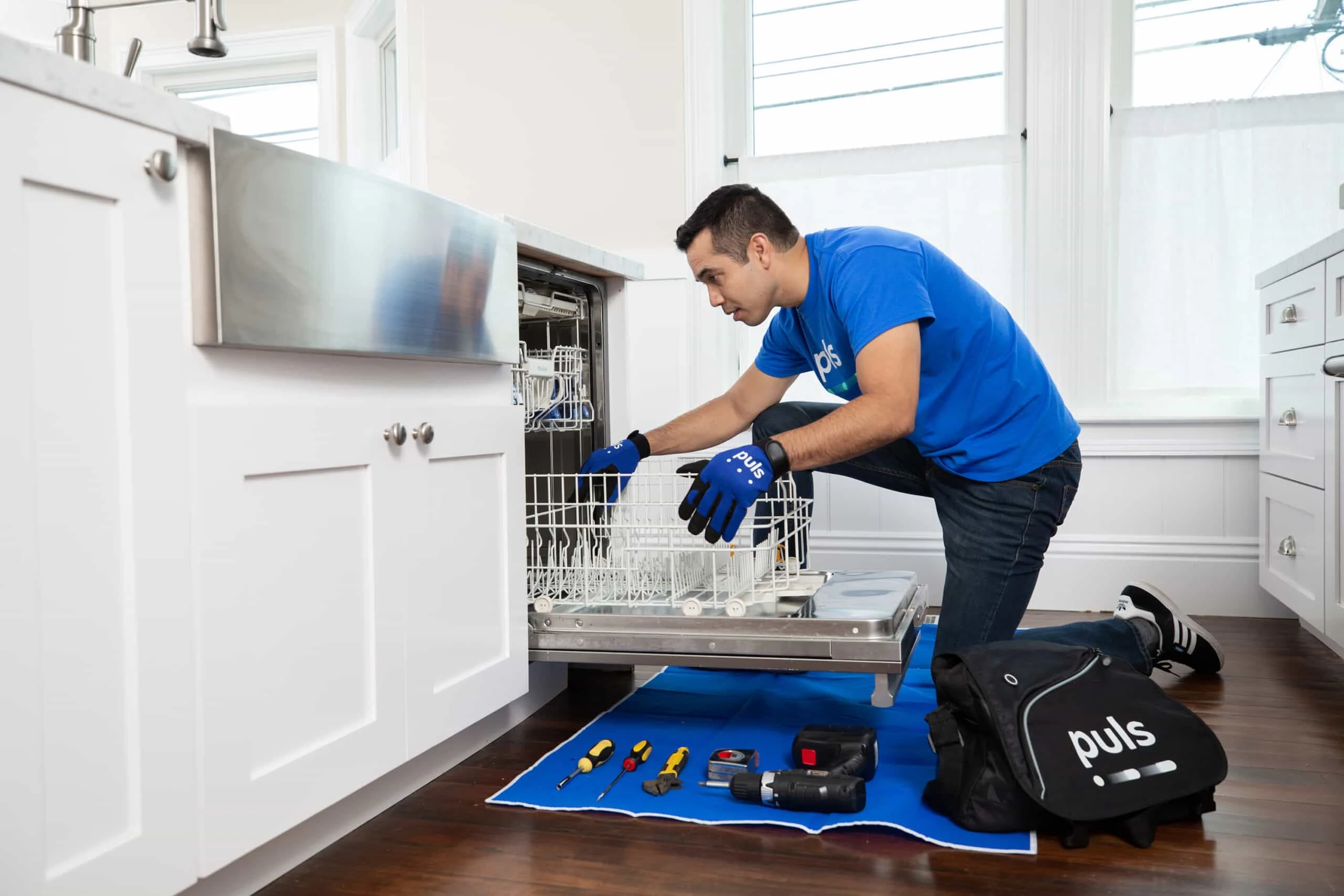 A Lady Lake technician inspecting a faulty stove burner